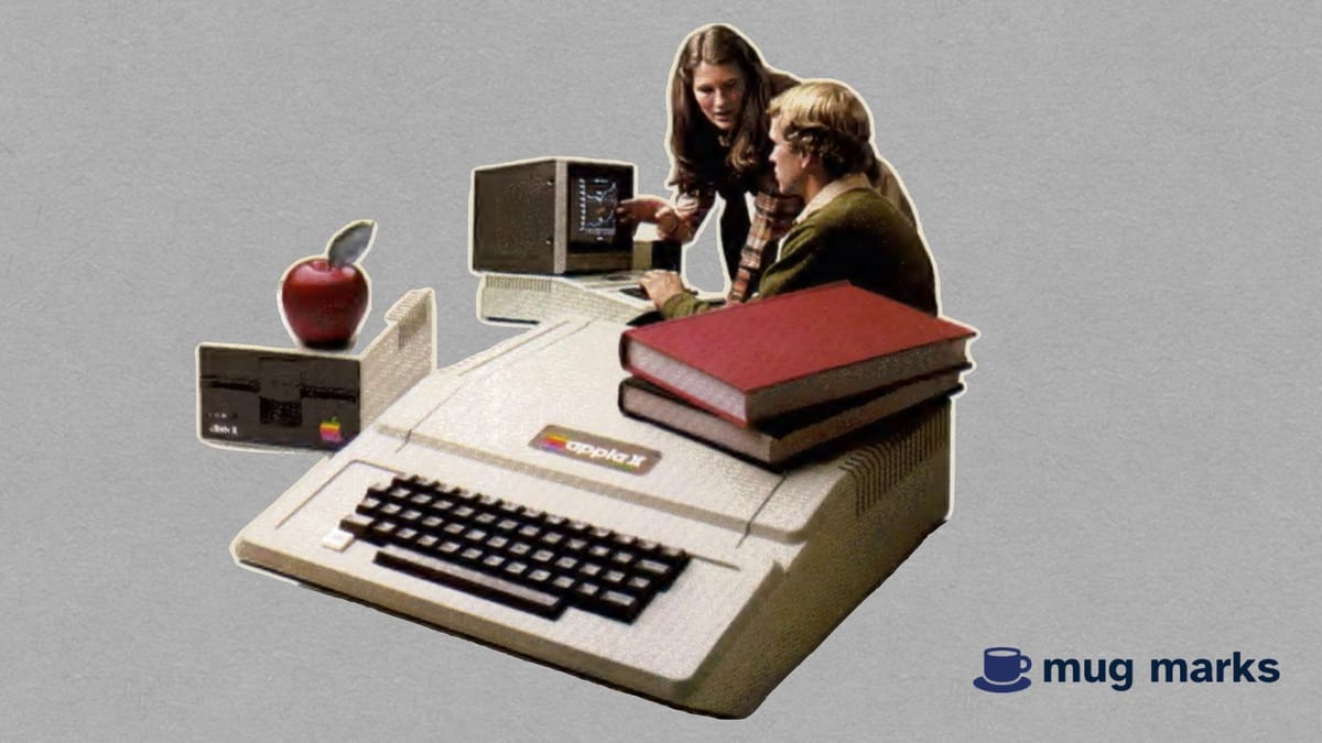 Two people looking at an Apple II screen, with an Apply II with books and an actual apple laying on top of the computer.